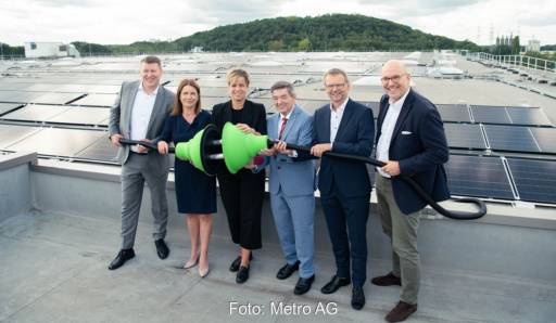 Im Bild Offizielle mit grünem Riesenstecker bei der Einweihung für die größte Photovoltaik-Dachanlage Deutschlands.
