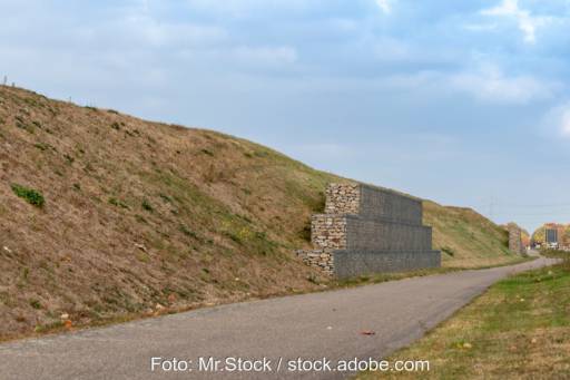 Ein Lärmschutz-Wall, an dessen Fuß ein Radweg verläuft - keine Photovoltaik-Anlage.