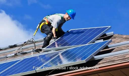 Arbeiter montiert PV-Module, Symbol für Photovoltaik in Österreich.