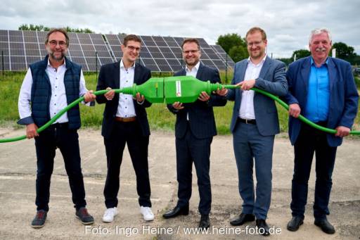 Eröffnung einer Photovoltaik-Anlage in Mecklenburg-Vorpommern: fünf Männer halten einen großen grünen Stecker.