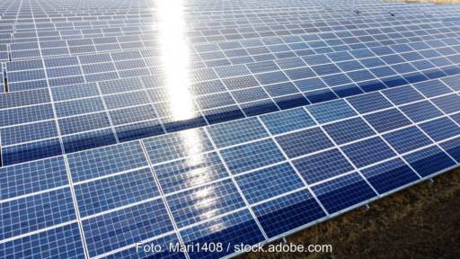 Freiflächen-PV-Park mit Modulen, die das Sonnenlicht reflektieren.