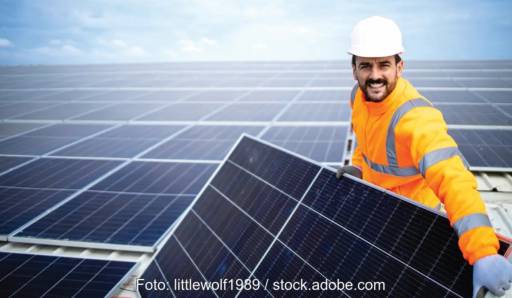 Im Bild ein Handwerker, der ein PV-Modul installiert, der Solar Module Quality Standard soll langfristige Energieerträge der Solaranlagen sicherstellen.
