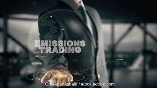 Eine Hand vor 3D-Animation mit Aufschrift Emissions Trading, der ETS-2-Emissionshandel soll sozial ausgestaltet werden.