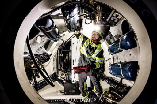 Ein Dekra-Prüfer bei einer Windenergieanlagen-Inspektion, die Prüforganisation stellt auf der Messe Husum Wind 2025 aus.