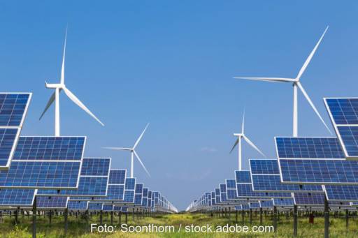 Bis zum Horizont Windanlagen udn Solarmodule unter blauem Himmel.
